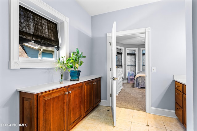 bathroom with vanity, tile patterned flooring, and a healthy amount of sunlight