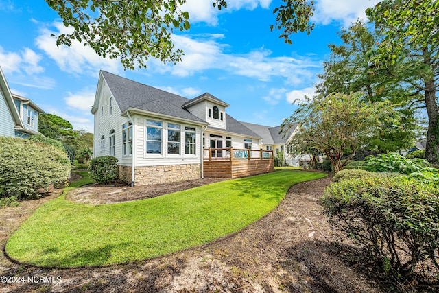 view of front of house with a front lawn and a deck