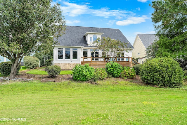 exterior space featuring a deck and a front lawn