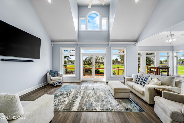 living room featuring a wealth of natural light, ceiling fan, and dark wood-type flooring