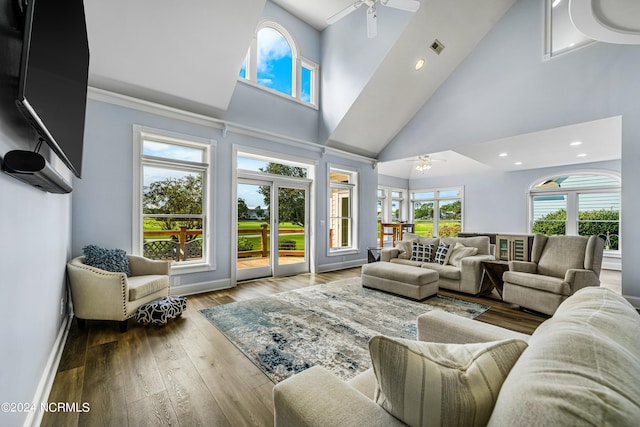 living room with ceiling fan, plenty of natural light, hardwood / wood-style floors, and high vaulted ceiling