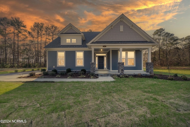 view of front of home featuring a porch and a lawn