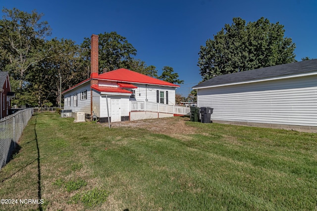 rear view of house with a yard