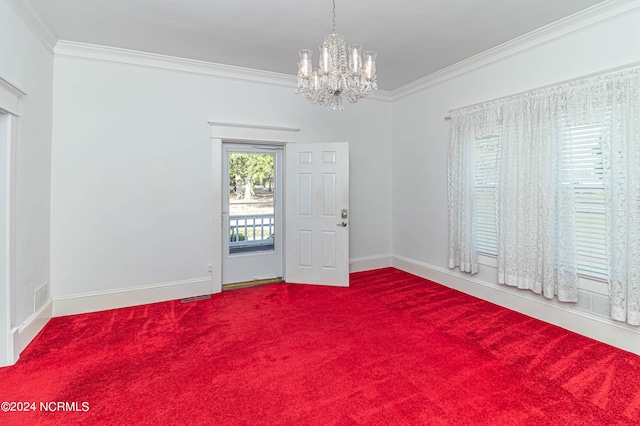 unfurnished room with carpet flooring, ornamental molding, and a notable chandelier