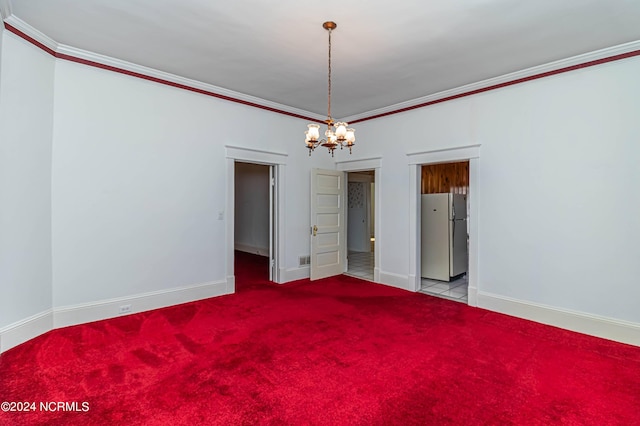 carpeted spare room featuring crown molding and an inviting chandelier