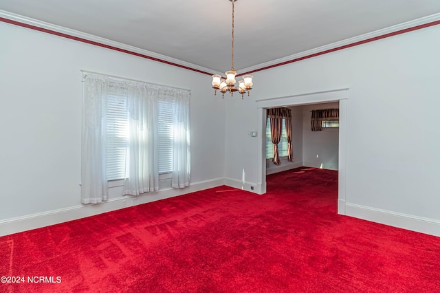 carpeted empty room with a notable chandelier and crown molding