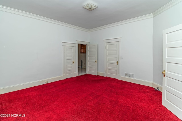 unfurnished bedroom featuring carpet floors and crown molding