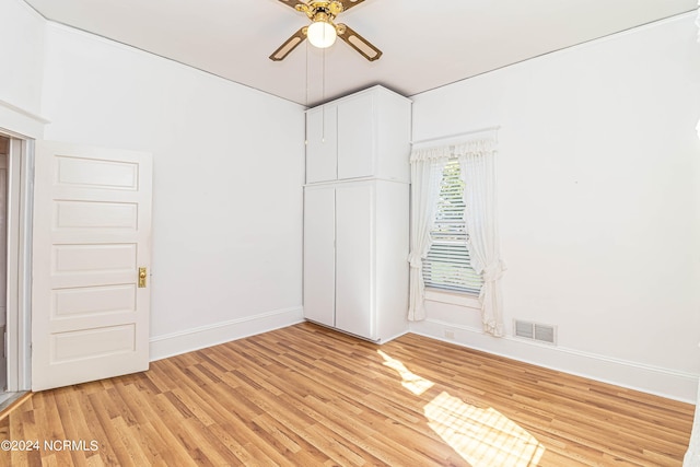 unfurnished bedroom with ceiling fan and light wood-type flooring