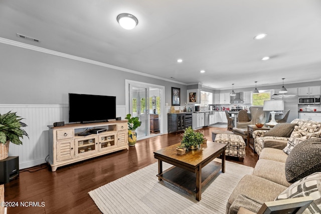 living room featuring ornamental molding, beverage cooler, and hardwood / wood-style floors