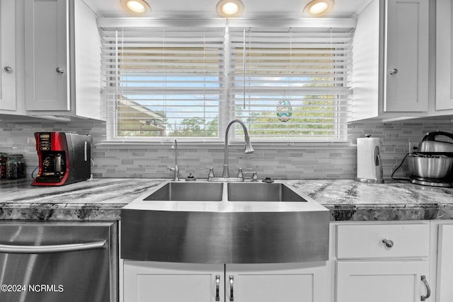 kitchen with backsplash, white cabinets, and a wealth of natural light