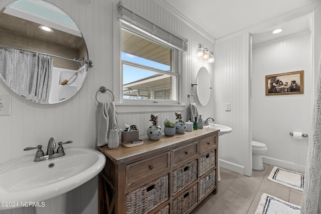 bathroom with ornamental molding, sink, tile patterned flooring, and toilet