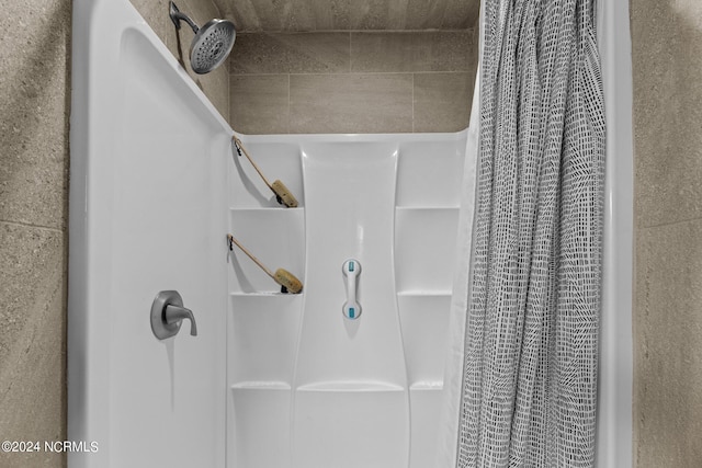 interior space with a shower with shower curtain