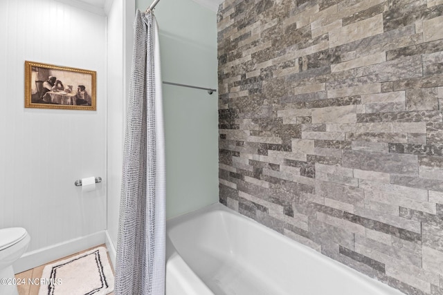 bathroom featuring shower / bathtub combination with curtain and toilet