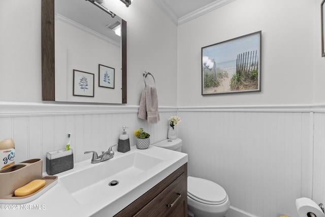 bathroom featuring ornamental molding, vanity, and toilet