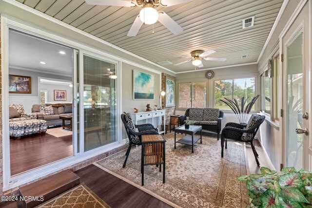 sunroom with wood ceiling and ceiling fan