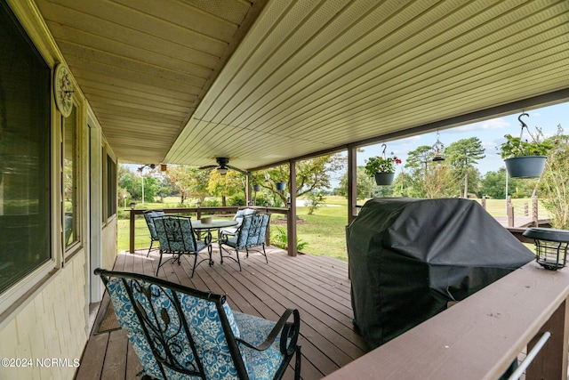 wooden deck with ceiling fan and grilling area