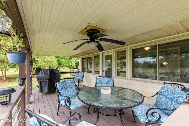 wooden terrace with ceiling fan and a grill