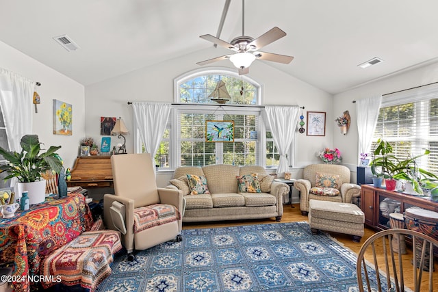 living room featuring ceiling fan, lofted ceiling, and hardwood / wood-style floors