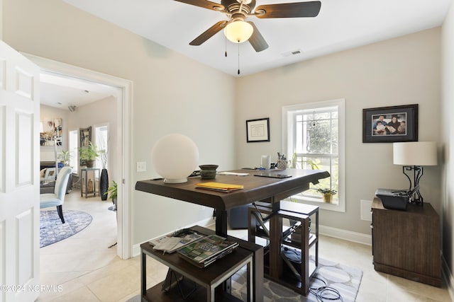 dining space with light tile patterned floors and ceiling fan