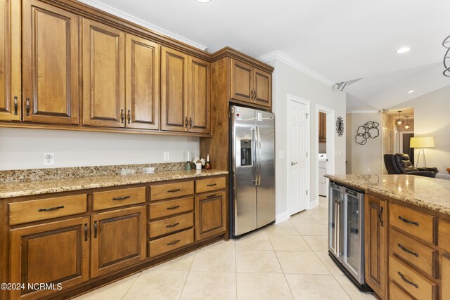 kitchen featuring light tile patterned flooring, crown molding, stainless steel fridge with ice dispenser, beverage cooler, and light stone countertops