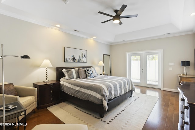 bedroom with dark wood-type flooring, french doors, crown molding, access to outside, and a raised ceiling