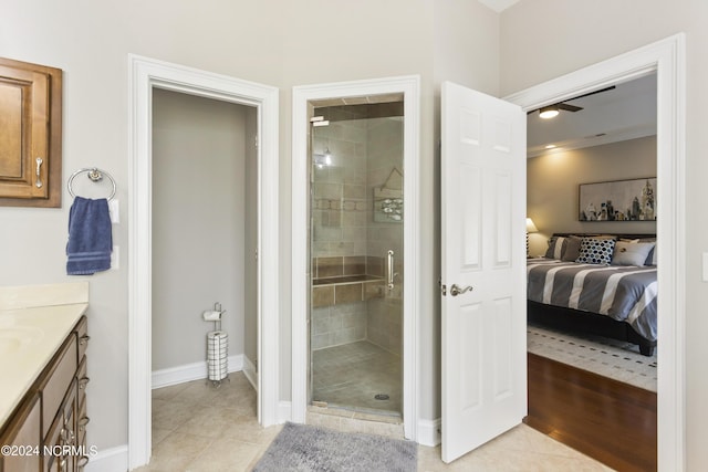 bathroom with tile patterned flooring, vanity, and walk in shower