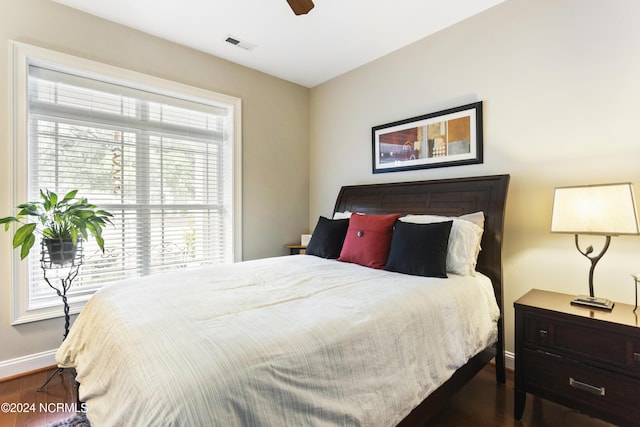 bedroom with dark hardwood / wood-style floors and ceiling fan