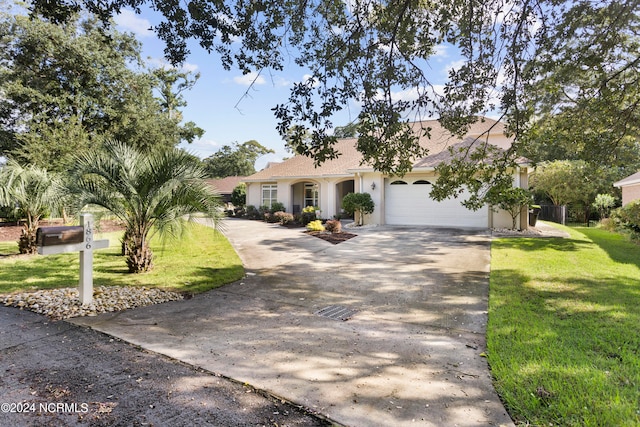 view of front facade with a garage and a front yard