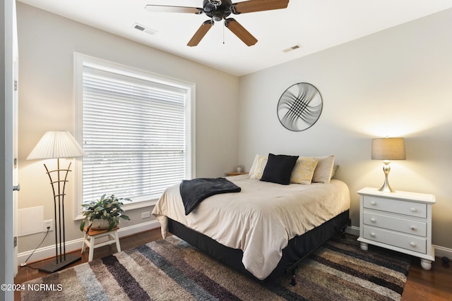 bedroom with ceiling fan and dark hardwood / wood-style flooring