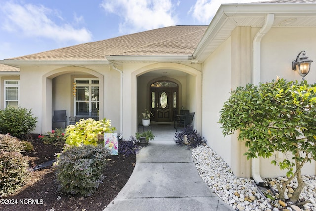 view of exterior entry with a porch