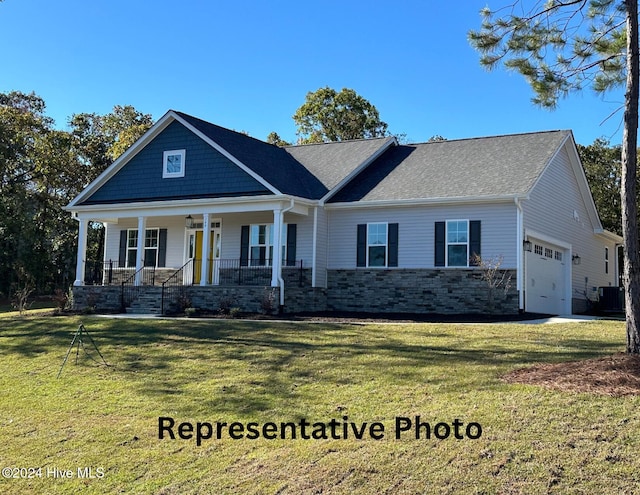 view of front of house with cooling unit, a front lawn, a porch, and a garage