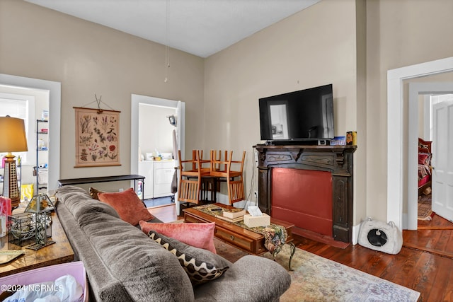 living room with dark hardwood / wood-style floors and washer and dryer