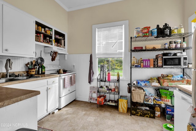 kitchen with white stove, ornamental molding, and white cabinetry