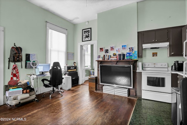 kitchen with dark brown cabinetry, dark hardwood / wood-style flooring, and white range with electric stovetop