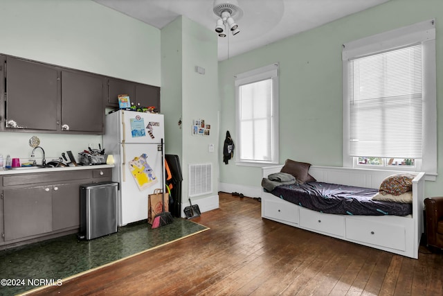 kitchen with white refrigerator, sink, and dark wood-type flooring