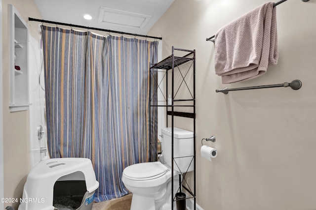 bathroom with a shower with shower curtain and toilet