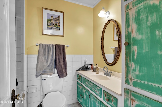 bathroom featuring tile walls, crown molding, vanity, and toilet