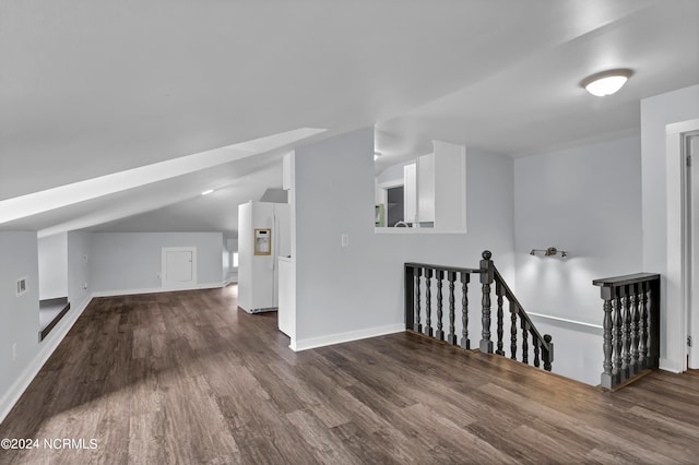 bonus room featuring vaulted ceiling and dark hardwood / wood-style flooring