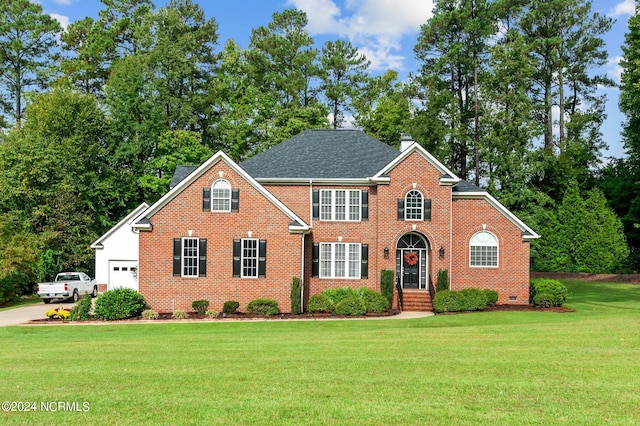 view of front property with a front yard and a garage