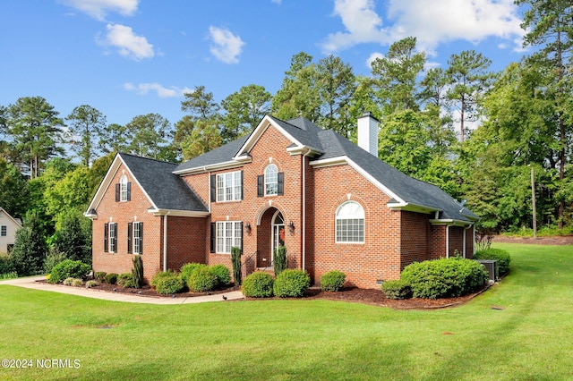 view of property featuring a front lawn