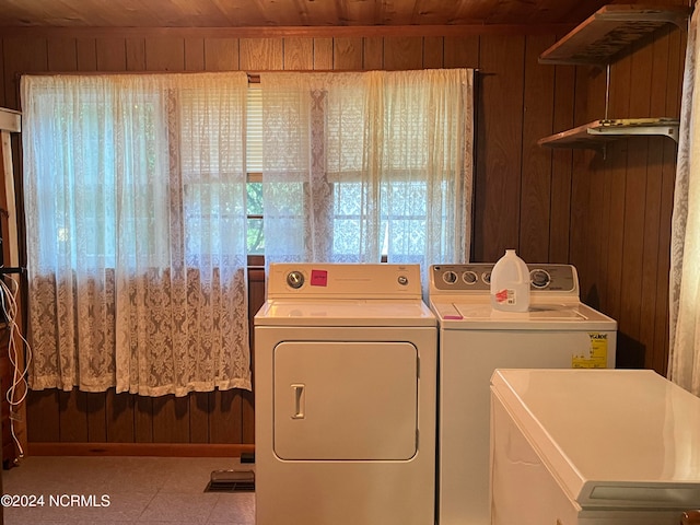 laundry room with washer and dryer, laundry area, wooden ceiling, and wood walls