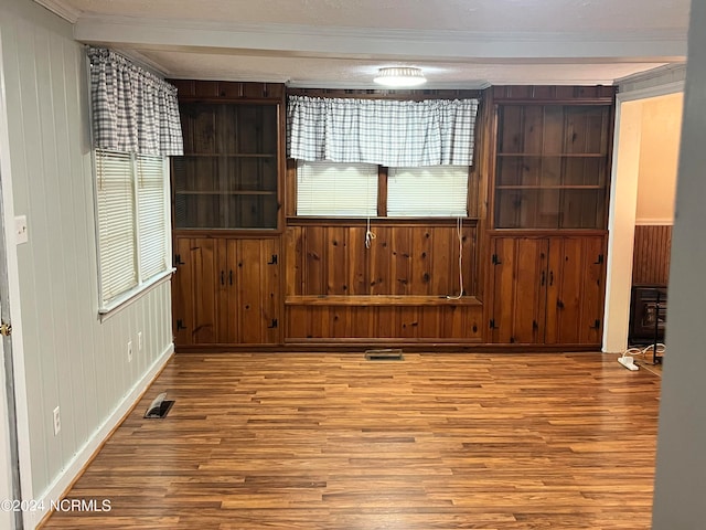 spare room featuring visible vents and wood finished floors