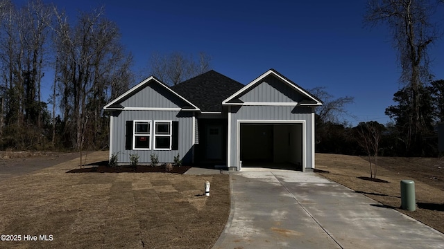 view of front facade with a garage, a shingled roof, board and batten siding, and concrete driveway