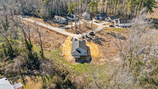 birds eye view of property with a wooded view