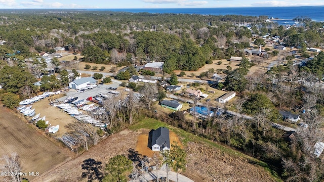 birds eye view of property with a wooded view