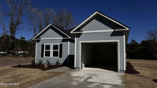 view of front of property with board and batten siding and concrete driveway