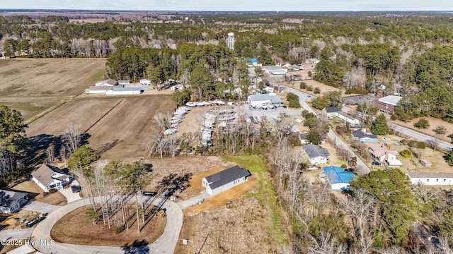 drone / aerial view with a wooded view