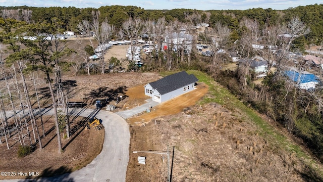 bird's eye view featuring a wooded view