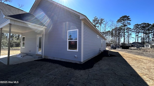 view of property exterior with roof with shingles