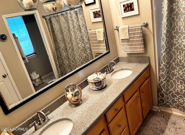 bathroom with vanity and curtained shower